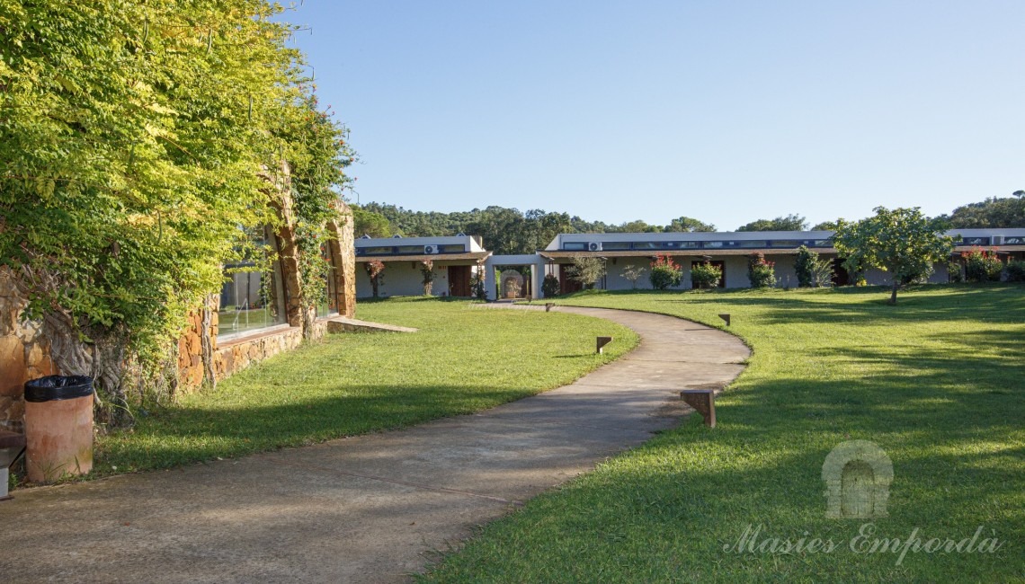 Indoor pool area garden with the bungalow area in the background of the picture 