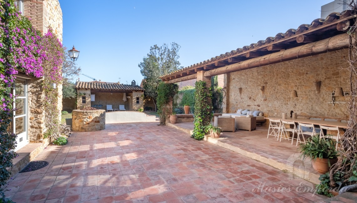 Views of the garden terrace, the summer porches and the swimming pool in the background of the image