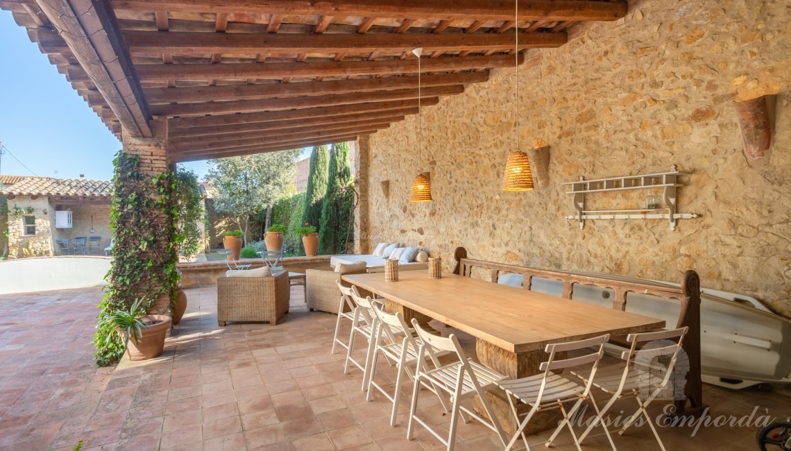 Views of the garden terrace, the summer porches and the swimming pool in the background of the image