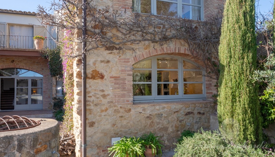 Views of the garden terrace, the summer porch and the swimming pool in the background of the image