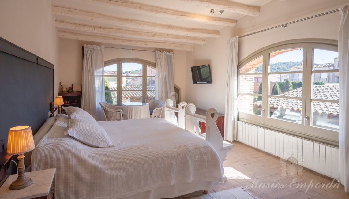 Master bedroom with exit to the terrace and views of the garden and swimming pool