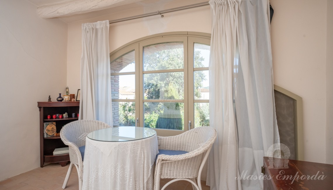 Master bedroom with exit to the terrace and views of the garden and swimming pool