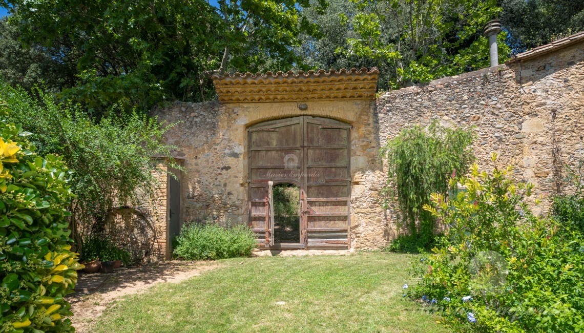 Garden door leading to the Santiago pine grove